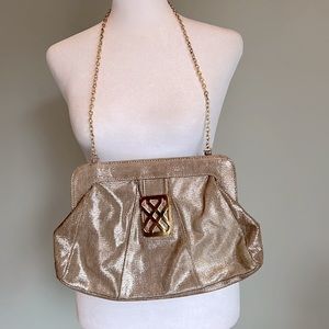 Gold tone clutch with chain. Never used. Excellent condition.